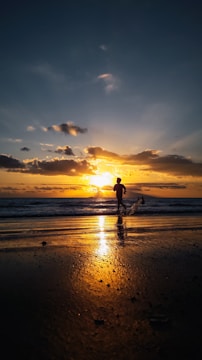 A powerful shot of a runner sprinting along a coastal trail at golden hour.