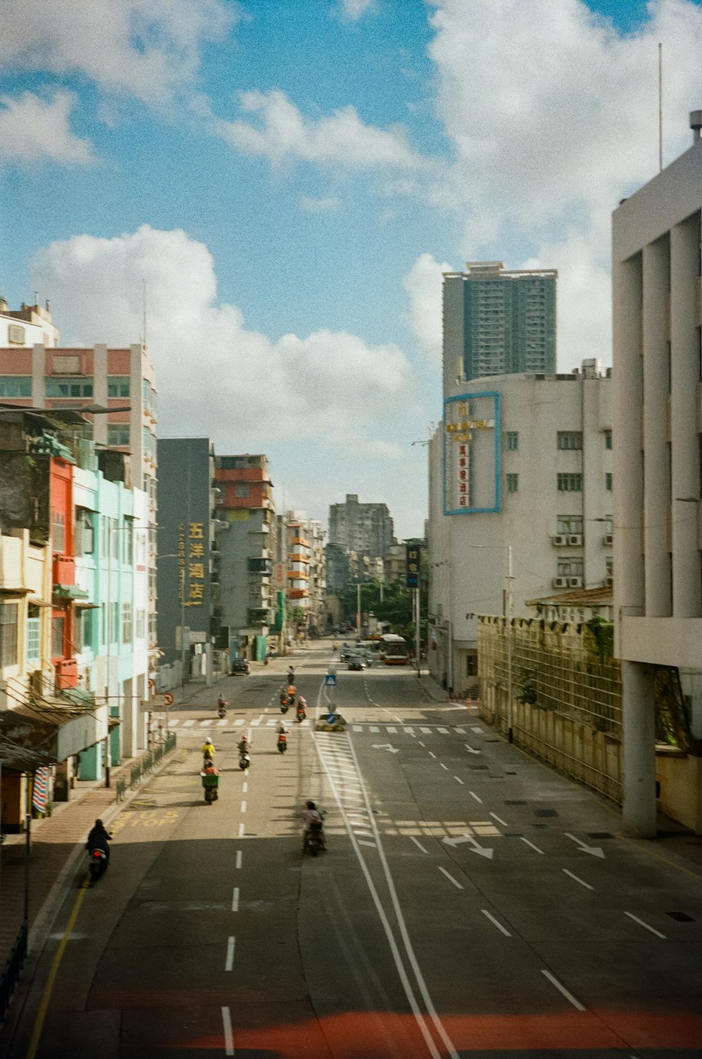 people walking on sidewalk near high rise buildings during daytime