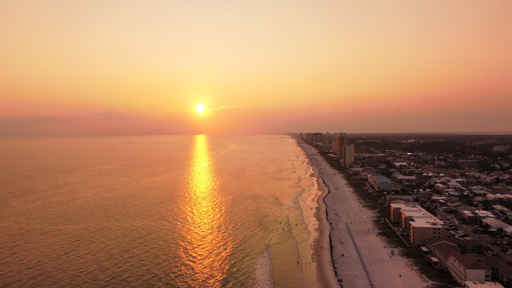 city buildings near sea during sunset