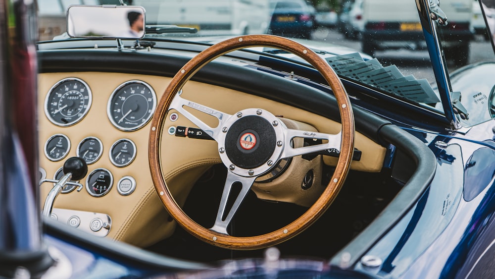 a steering wheel and dashboard of a classic car