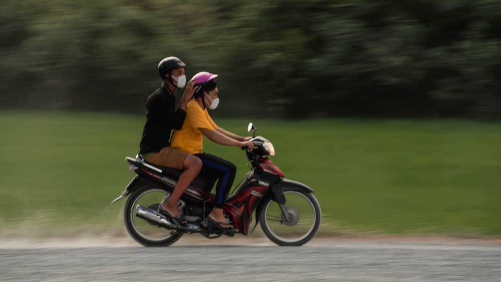 man in yellow shirt riding motorcycle on road during daytime