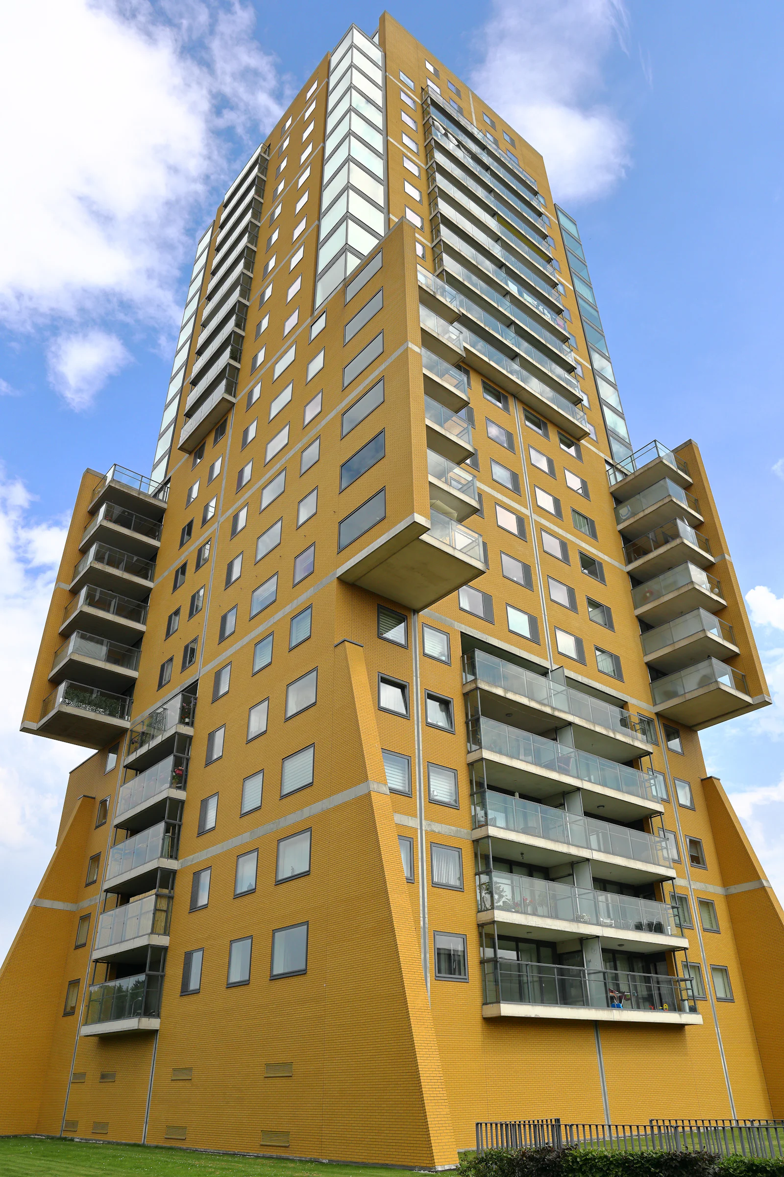 Balconied condominium building under blue sky