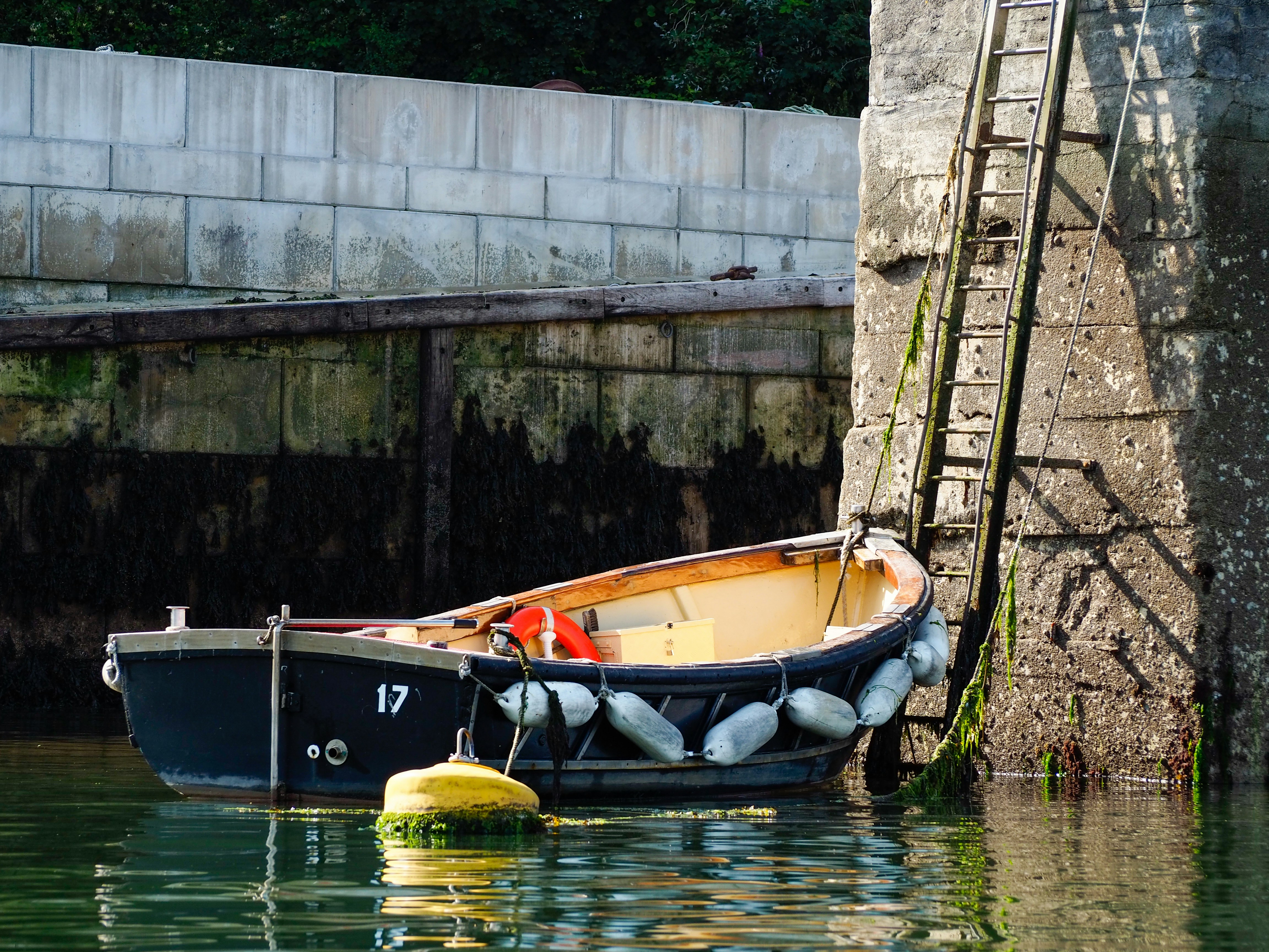 brown and black boat on body of water during daytime