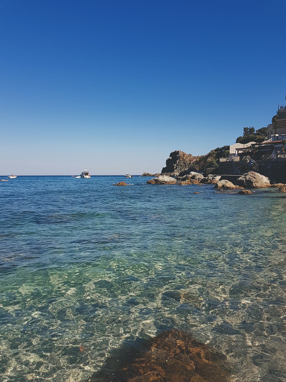 people swimming on sea during daytime