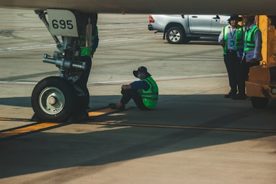 Technician inspecting aircraft ground support equipment on the tarmac.