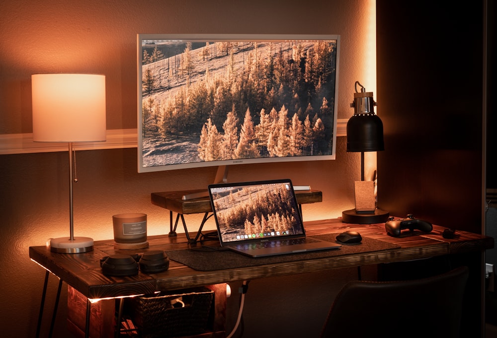 black laptop computer on brown wooden table