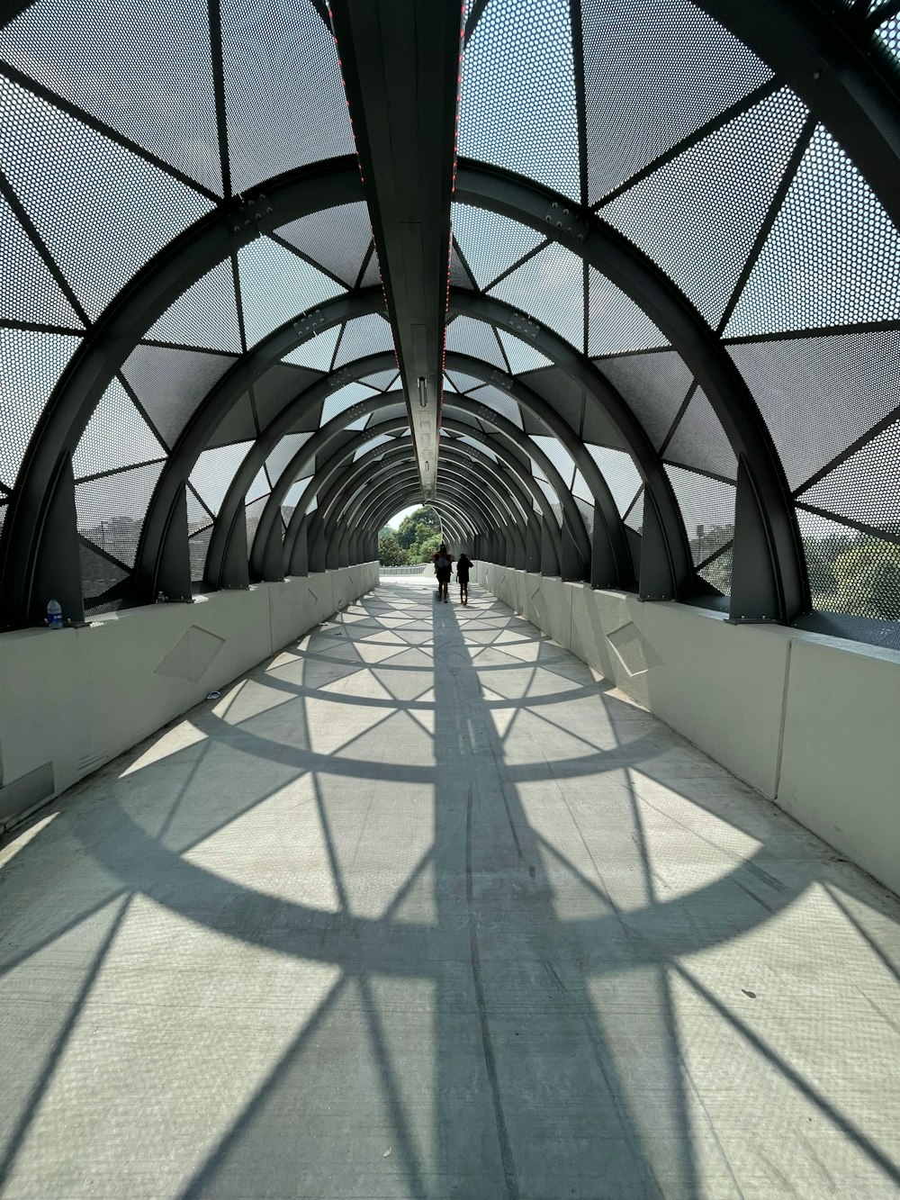 people walking on white and gray tiled floor