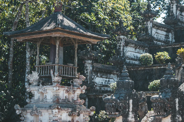 lingam massage in Ubud, a carved temple pavilion among tropical greenery