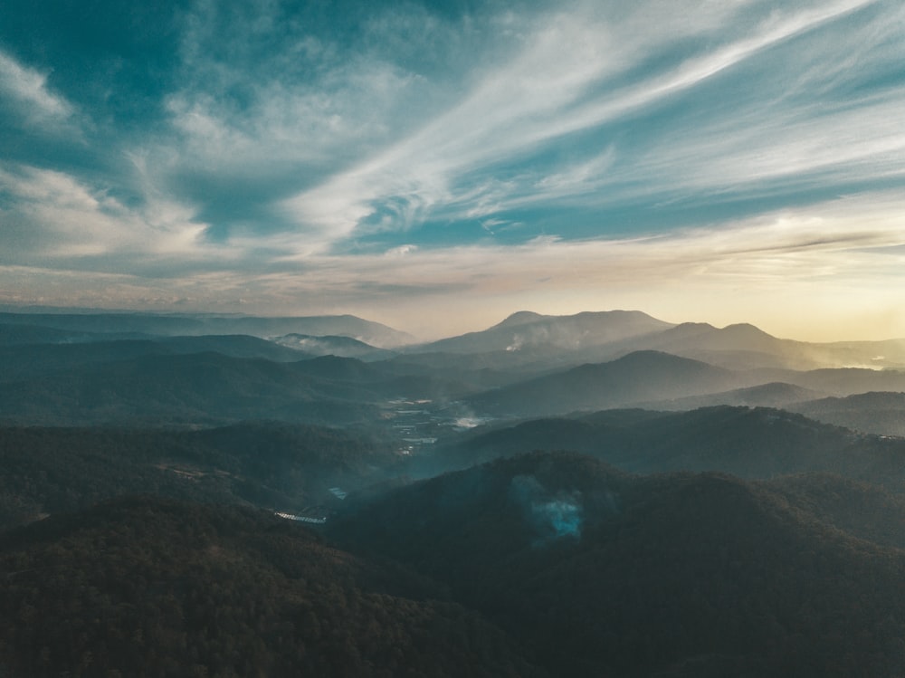 aerial view of mountains under blue sky during daytime