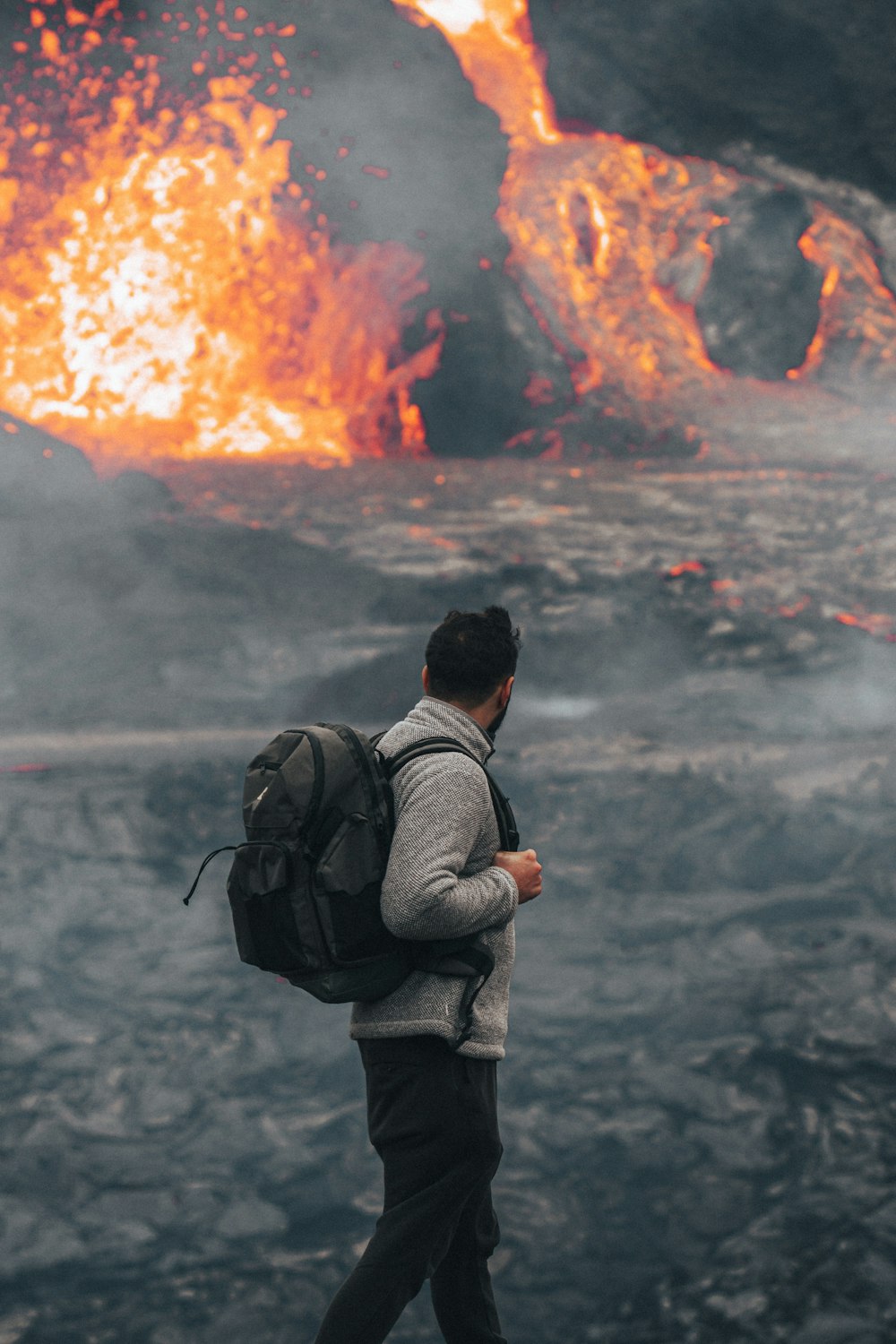 man in black jacket and gray pants carrying black backpack