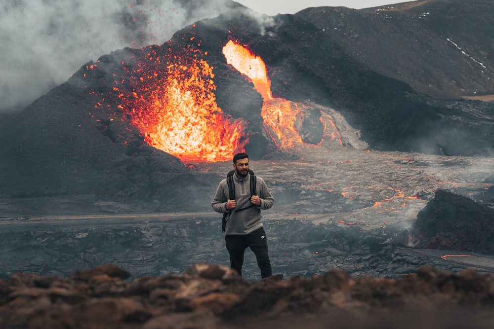 woman in black jacket standing near bonfire