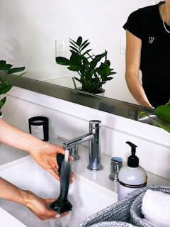 person holding black plastic bottle