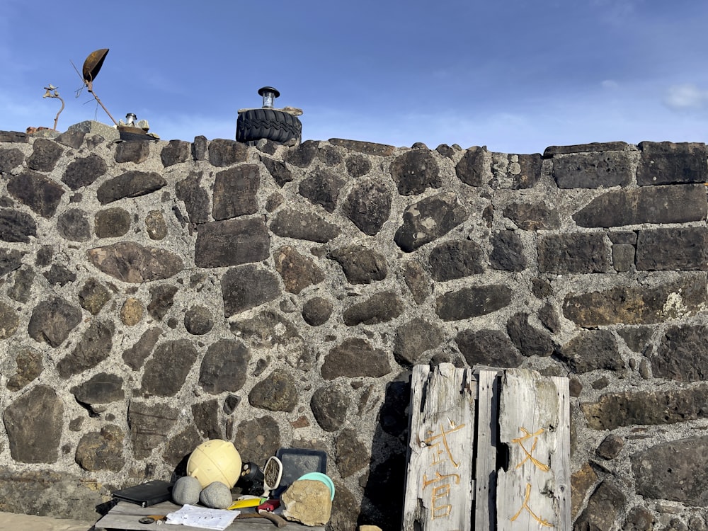 yellow and blue inflatable ball beside gray concrete wall