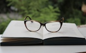 brown framed eyeglasses on book page