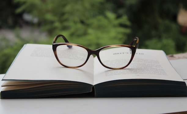 brown framed eyeglasses on book page