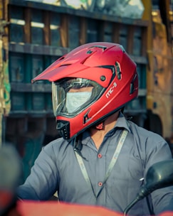 man in black leather jacket wearing red helmet