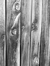 Close-up of a warm-toned western red cedar board on board fence, showcasing the natural grain and texture.