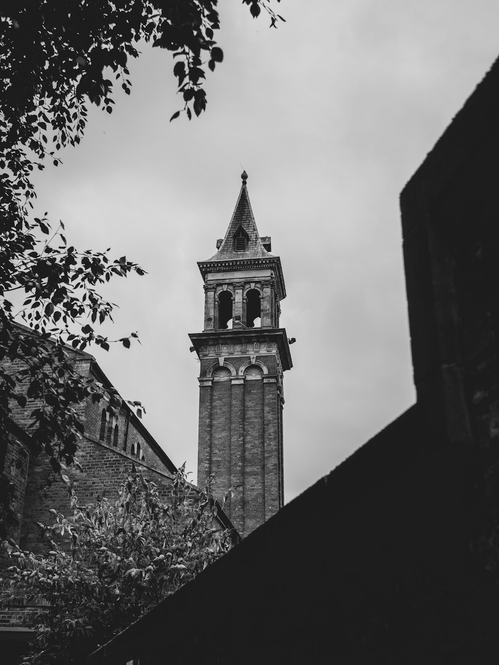 grayscale photo of concrete tower