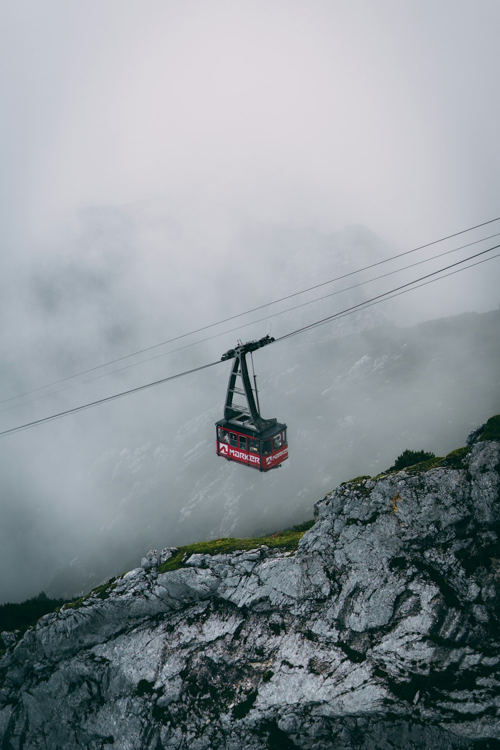 red cable car over the clouds