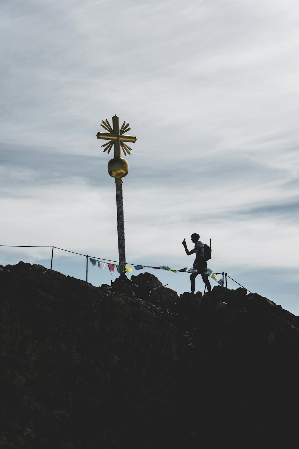 silhouette of 2 person standing on top of hill during daytime