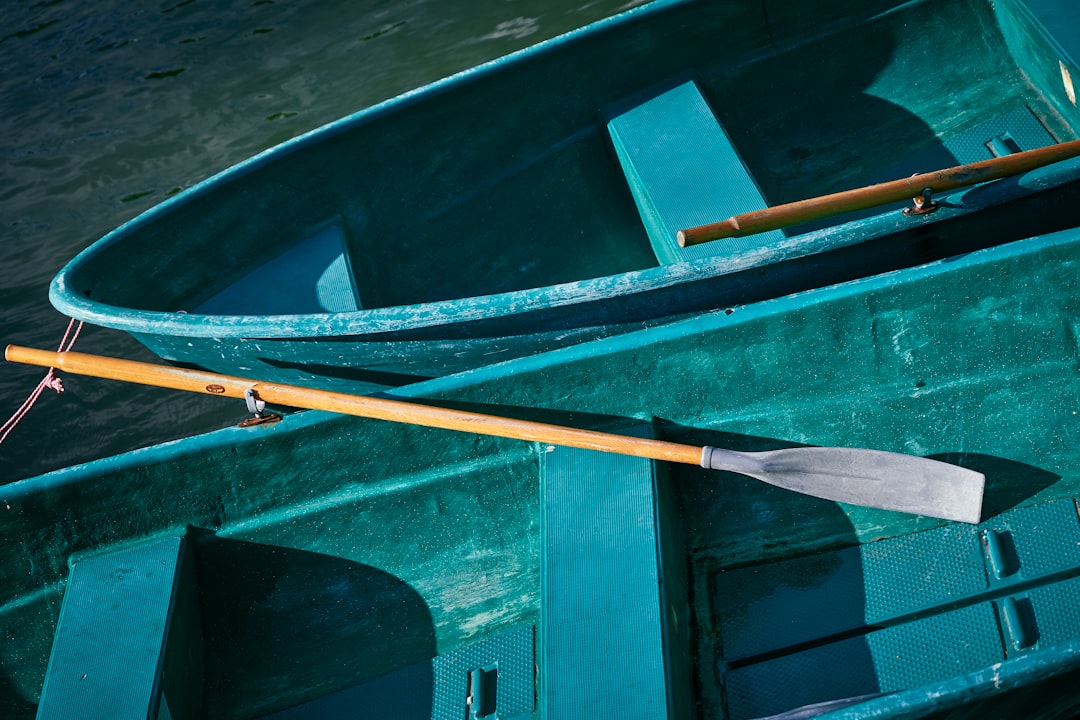 brown wooden boat on body of water