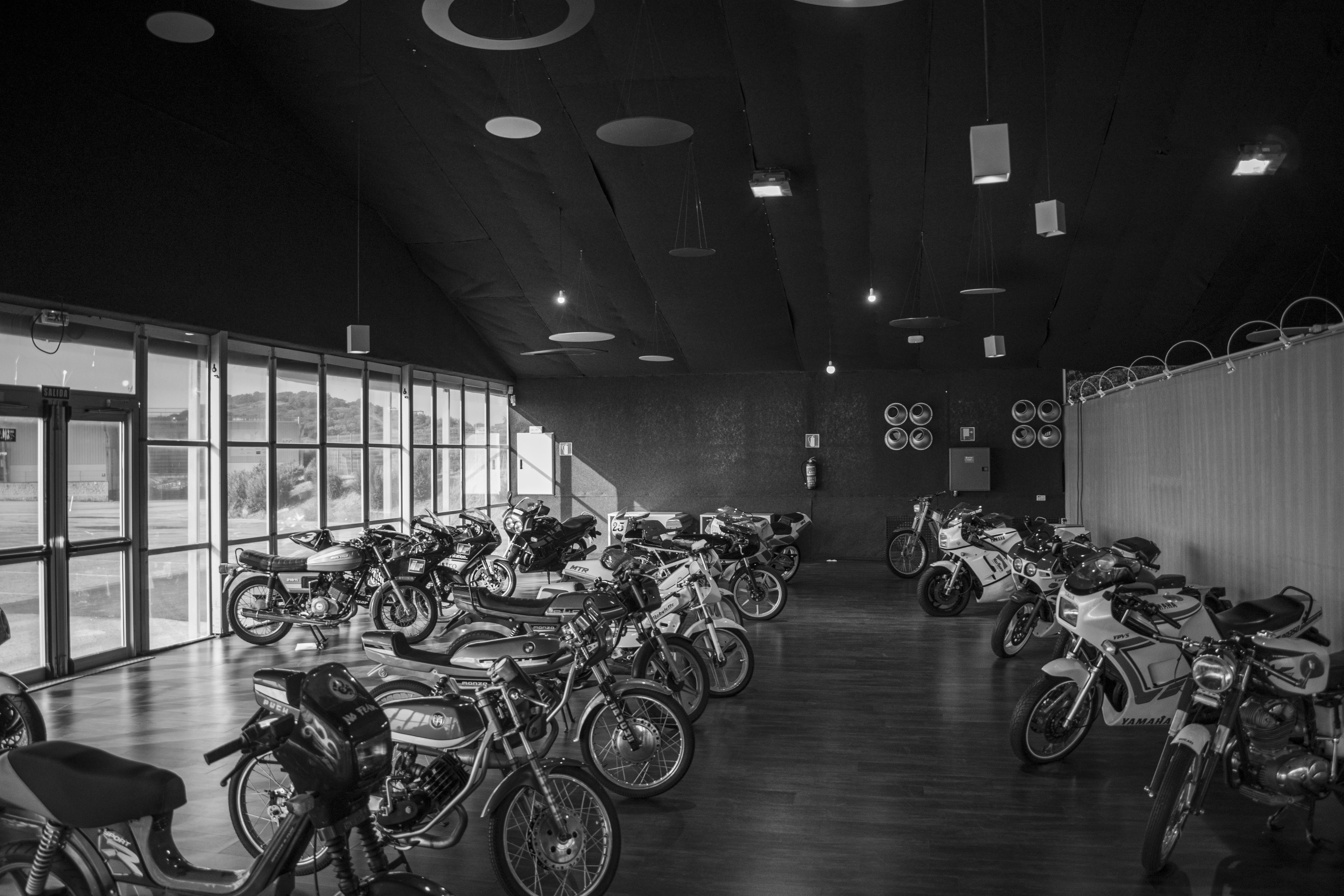 Grayscale motorcycles parking