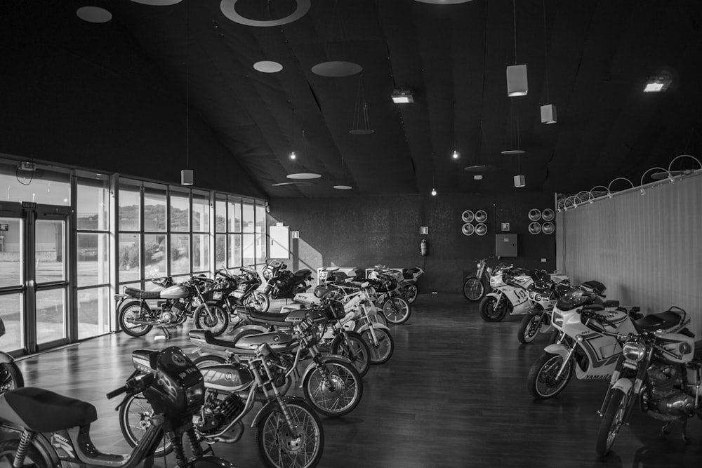 grayscale photo of bicycles parked on a parking lot