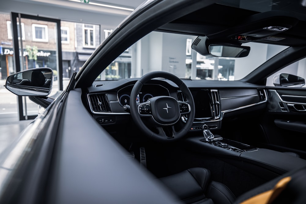 black car steering wheel during daytime