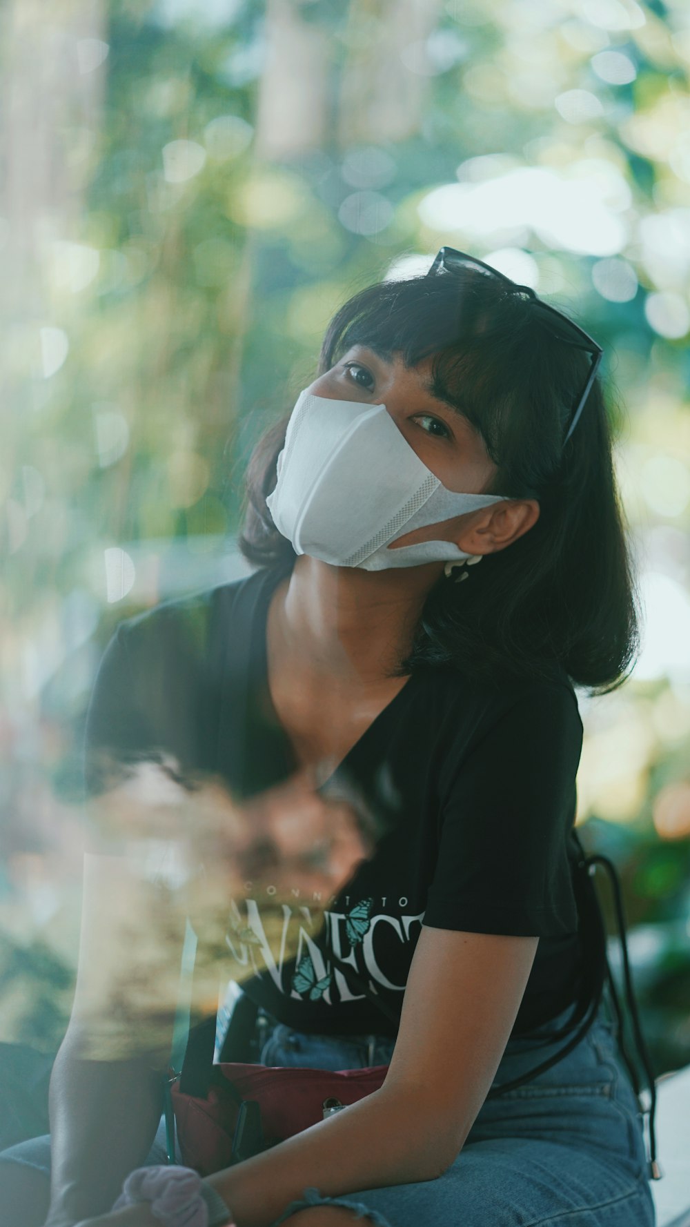 woman in black shirt wearing white face mask