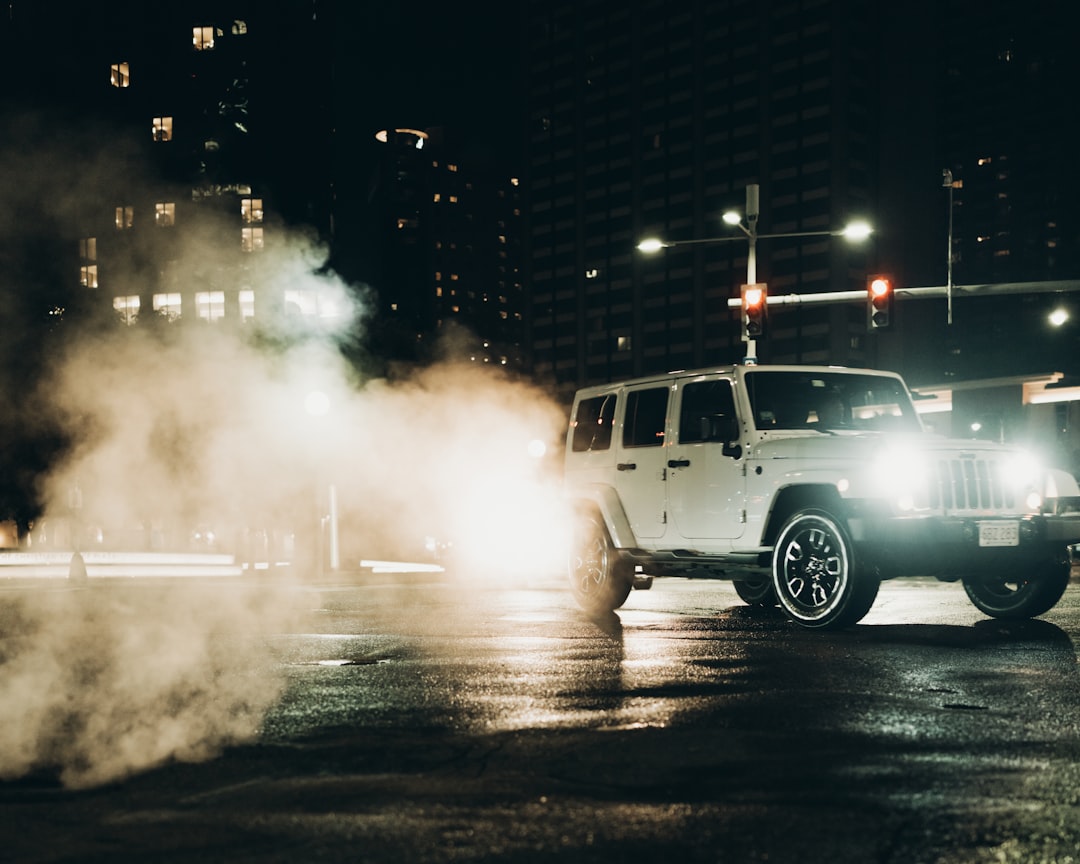 white suv on road during night time