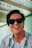 man in white and blue stripe button up shirt wearing black sunglasses