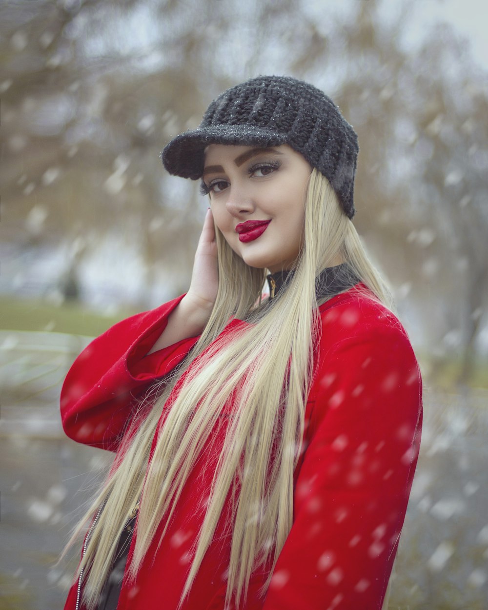 woman in red long sleeve shirt and black knit cap