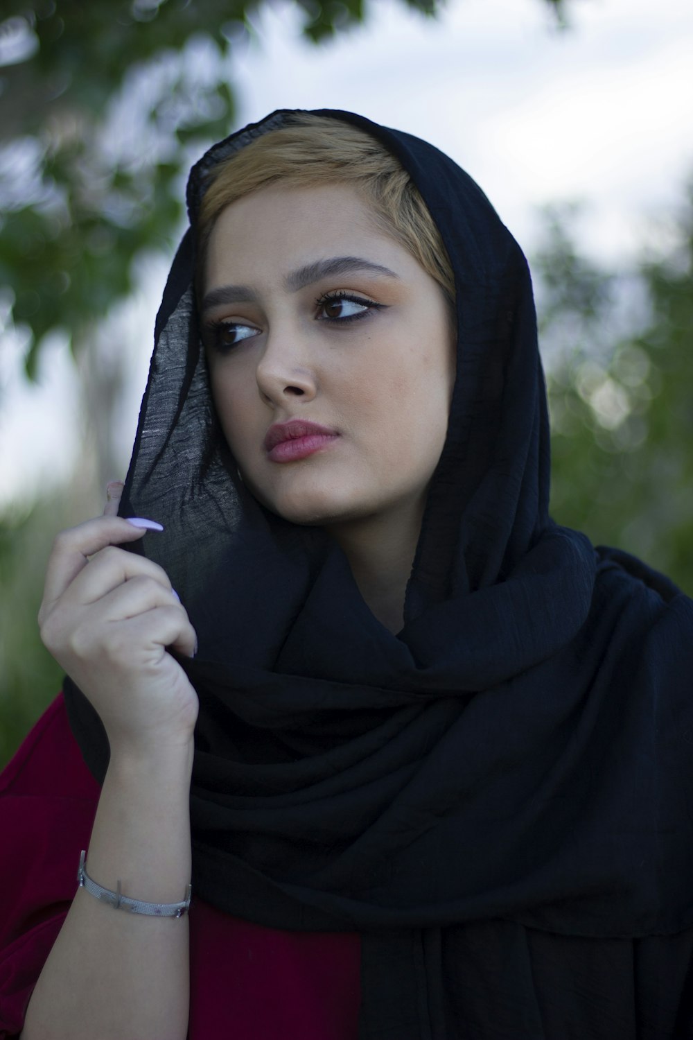 woman in black hijab taking selfie