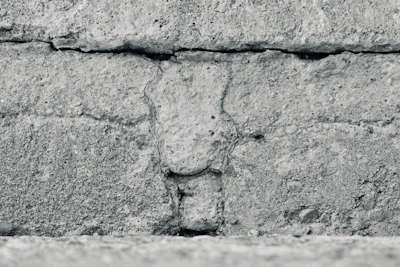 Close-up of textured concrete walls from Kinshasa, highlighting brutalist patterns and grain.
