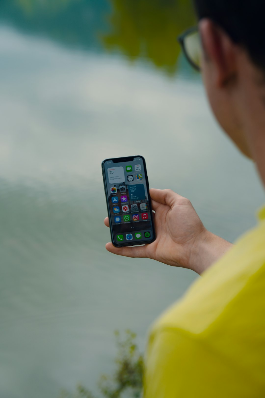 person holding iphone 6 with yellow case