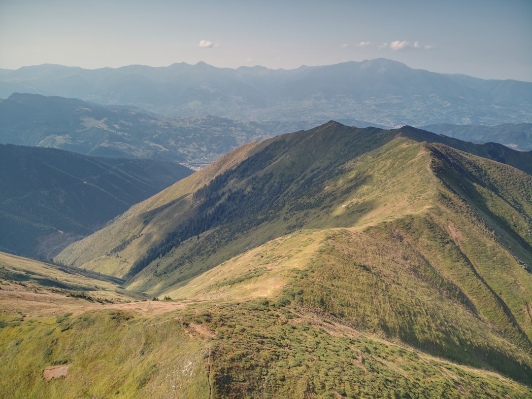 green and brown mountains under blue sky during daytime