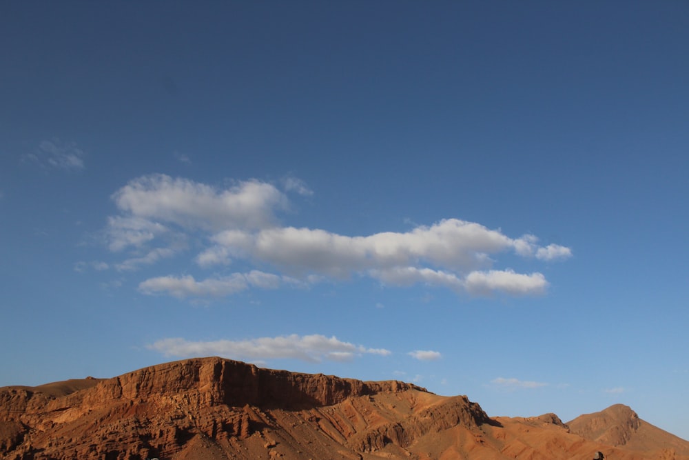 brown rocky mountain under blue sky during daytime