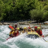 people riding on yellow kayak on river during daytime