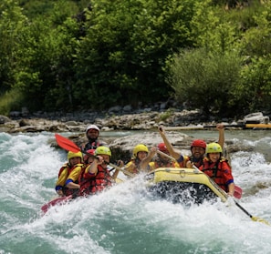 people riding on yellow kayak on river during daytime