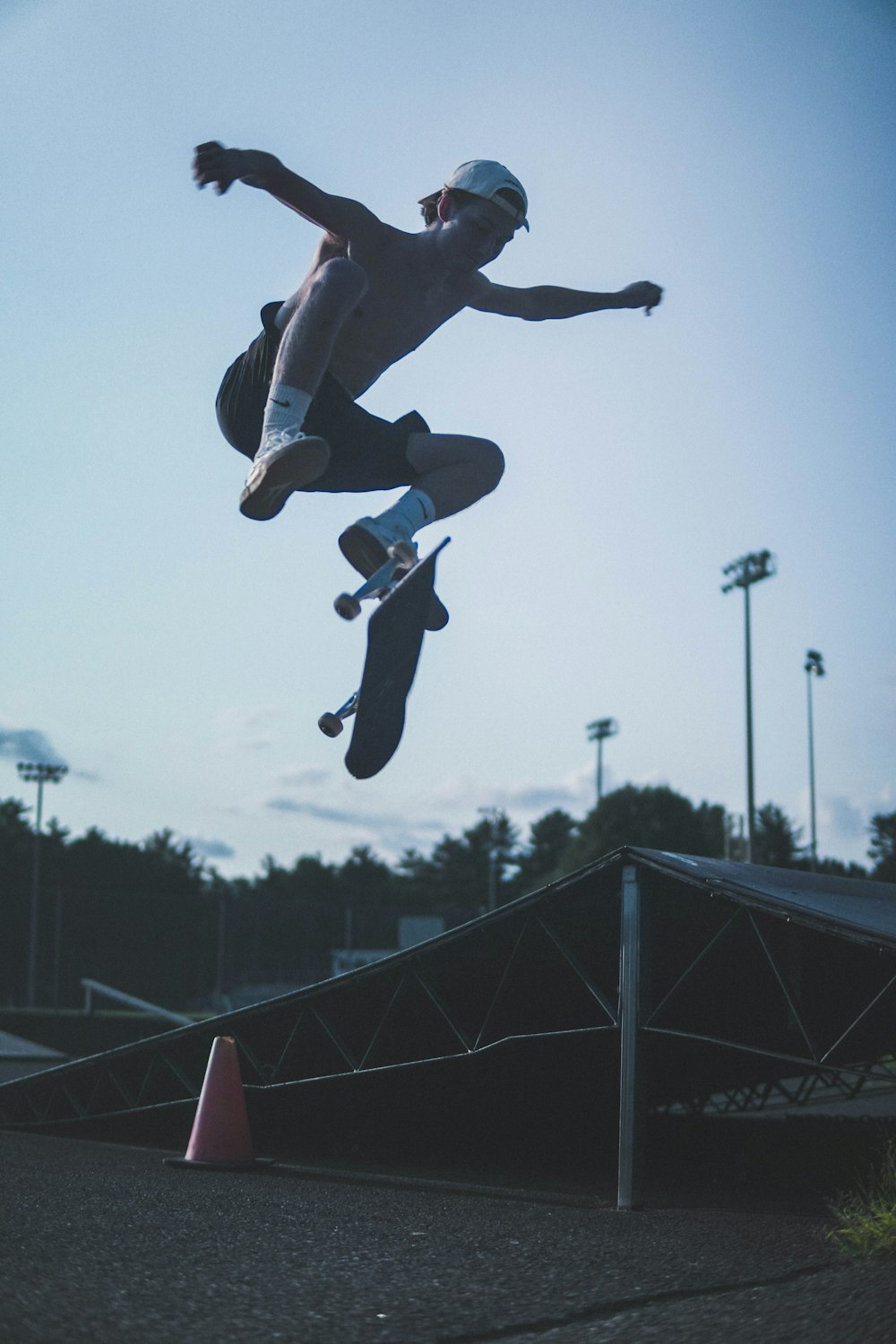 man in black pants and black shoes jumping during daytime