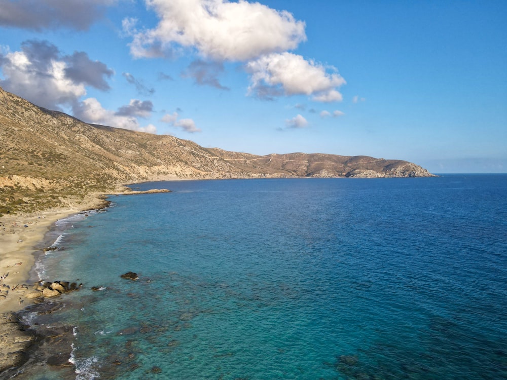 blue sea under blue sky and white clouds during daytime