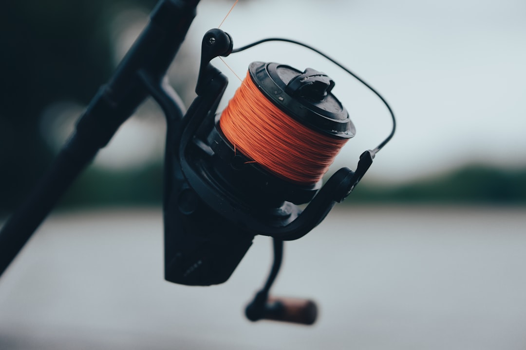 black and orange fishing reel