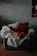A warm living room with soft cushions and a knitted blanket on a sofa.