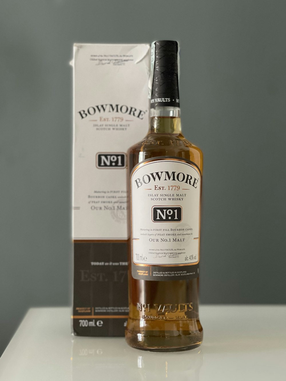 a bottle of bowmore no 1 whisky next to a box