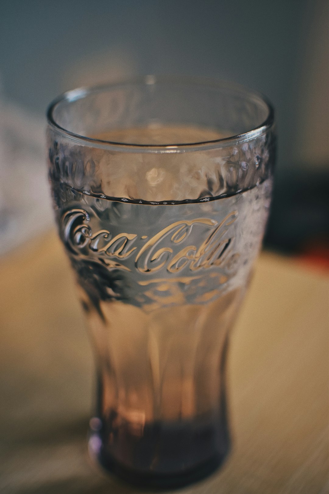 coca cola drinking glass on brown table
