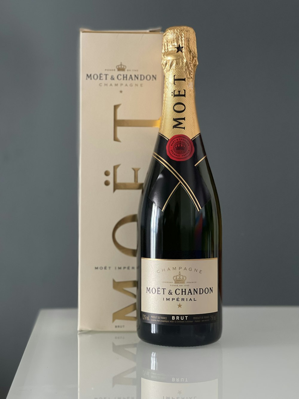 a bottle of champagne next to a box of wine