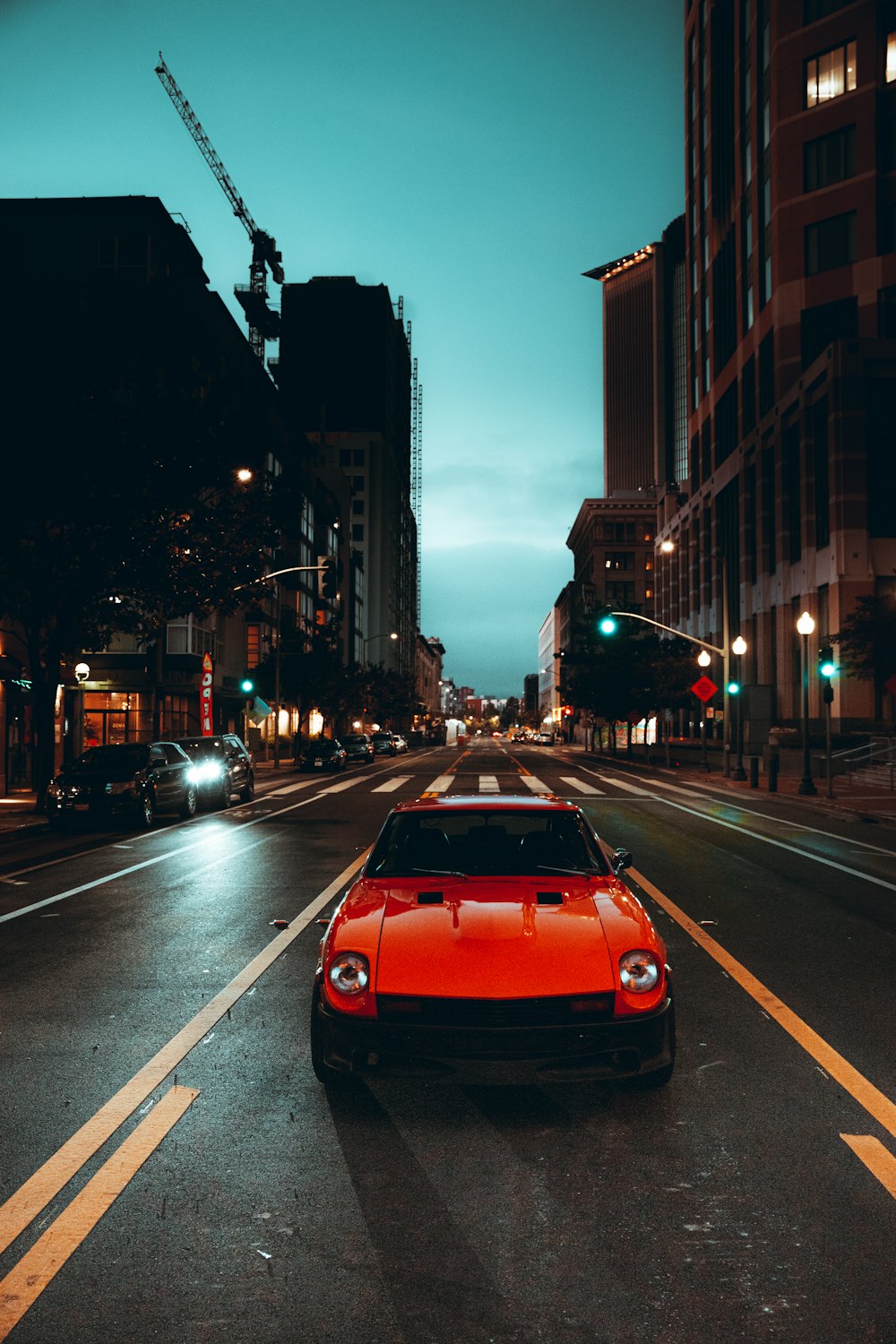 red car on road during night time