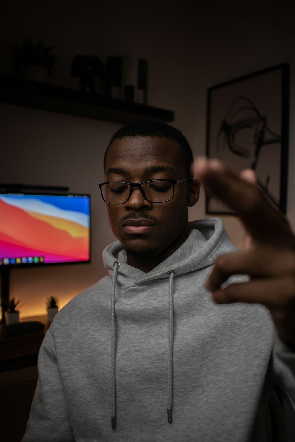 man in gray hoodie wearing black framed eyeglasses