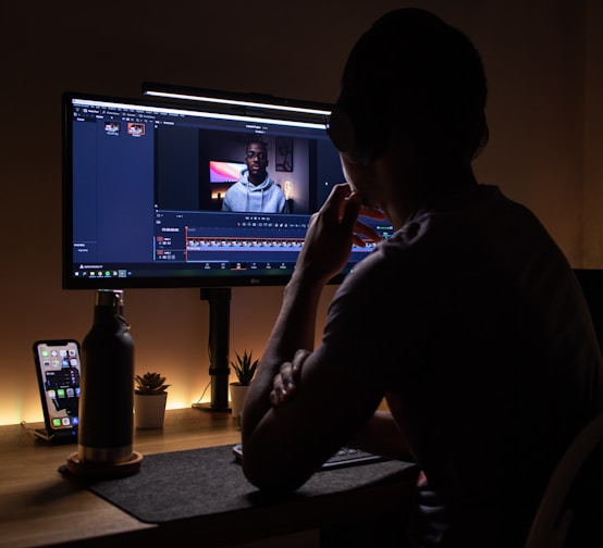 boy in black long sleeve shirt sitting on chair in front of black flat screen tv