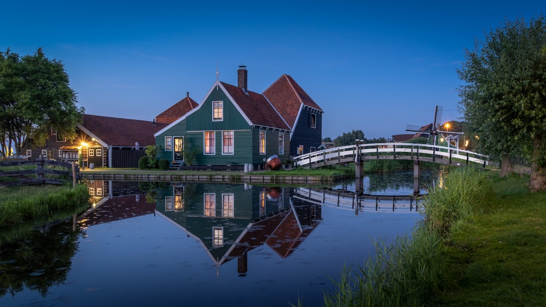 brown and white house beside body of water during daytime